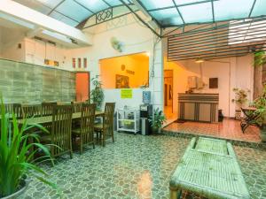 a restaurant with a table and chairs in a room at RedDoorz @ Seturan Raya in Yogyakarta