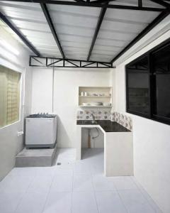 a kitchen with a stove and a counter top at Ben & Ben - Unit 2 in Cebu City +2 photos