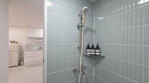 a shower with two bottles of wine in a bathroom at Stay Ali in Gyeongju +48 photos