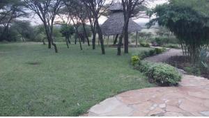 a park with trees and a gazebo in the grass at Empiris homestay in Sekenani