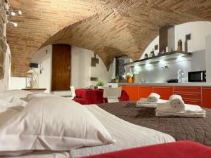 a bedroom with a large bed with towels on it at Charming Studio with Brick Vaulted Ceilings in Perugia
