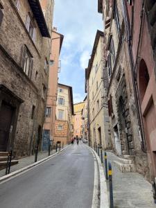 an empty street in an alley between two buildings at Charming Studio with Brick Vaulted Ceilings in Perugia