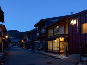 an empty street in an asian town at night at The Cross Inn Gujo in Gujo
