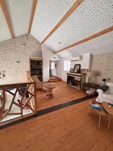 a large living room with a couch and a piano at Les Anges de la Vigne par Lisca Begay in Biron