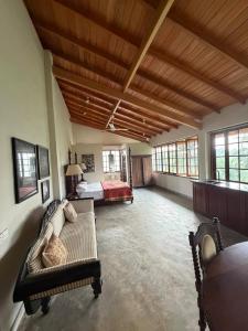 a large room with a bed and a couch at Weaver Bird Residencies in Hewagama