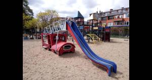 a playground with a slide in the sand at La Boulangerette - Studio in Kralingen in Rotterdam