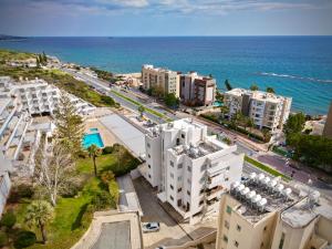 an aerial view of buildings and the ocean at Aphrodite Limassol Apartment in Limassol
