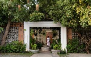 a person standing in the doorway of a building at Home Indochine d'Angkor Hotel in Siem Reap