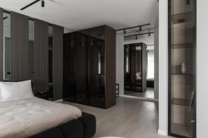a bedroom with a bed and some glass shelves at MM GROUP APARTMENT Dastor in Uzhhorod