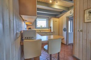 a kitchen with a table and some chairs in it at Wildgans Classic 248 in Mirow +43 photos