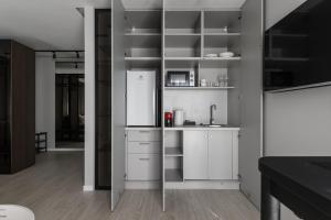 a kitchen with white cabinets and a refrigerator at MM GROUP APARTMENT Dastor in Uzhhorod