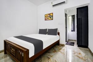 a bedroom with a large bed in a room at Hotel O EVA RESIDENCY in Cochin