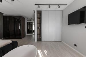 a living room with a bed and a tv at MM GROUP APARTMENT Dastor in Uzhhorod