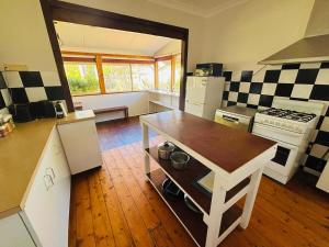 a kitchen with a counter and a stove top oven at The Mango Shack in Carnarvon