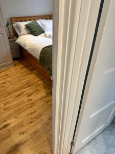 a door leading into a bedroom with a bed at Airy 3 bedroom House in Norwood +10 photos