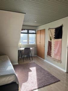 a bedroom with a bed and a table and a rug at Charming townhouse in CityCenter Townhouse - free parking in Odense