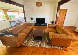 a living room with a couch and a coffee table at The Mango Shack in Carnarvon