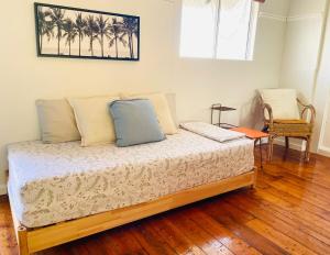 a bed with two pillows on it in a room at The Mango Shack in Carnarvon