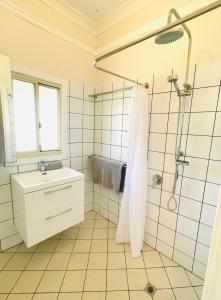 a bathroom with a shower and a sink at The Mango Shack in Carnarvon +21 photos