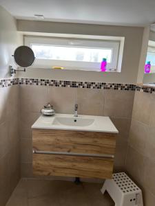 a bathroom with a sink and a window at Dans ma Campagne in Mecquignies
