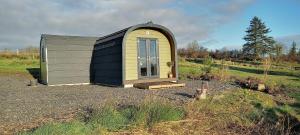 a black and yellow tiny house in a field at Stag's View in Ballina