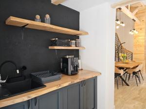 a kitchen with a sink and a counter with a coffee maker at FurtuNest in Roşcoiu
