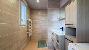 a small bathroom with a sink and a shower at Cocon chaleureux proche Epinal Private parking in Uxegney +42 photos