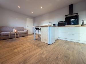 a living room with a kitchen and a counter top at Cocon chaleureux proche Epinal Private parking in Uxegney