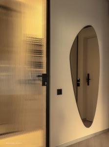 Ein Spiegel an einer Wand neben einer Tür in der Unterkunft Hotel Laudon in Uschhorod