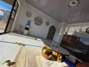 a living room with a glass table and a rug at Elclassico Villa in Nyanda