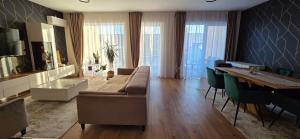 a living room with a couch and a table at Anca House in Baia Mare