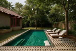 a swimming pool with lounge chairs and a house at Seclude Hampi 1800 in Sandūr