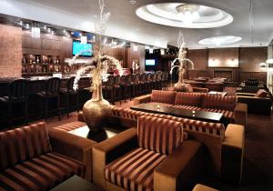 eine Bar mit braunen Ledersesseln und -tischen in einem Restaurant in der Unterkunft Residence Hotel in Donovaly