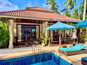 a villa with a swimming pool and a house at Sibaja Palms Sunset Beach Luxury Apartments in Taling Ngam Beach