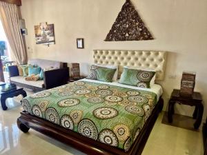 a bedroom with a large bed and a couch at Sibaja Palms Sunset Beach Luxury Apartments in Taling Ngam Beach