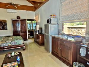 a kitchen with a sink and a refrigerator at Sibaja Palms Sunset Beach Luxury Apartments in Taling Ngam Beach +24 photos