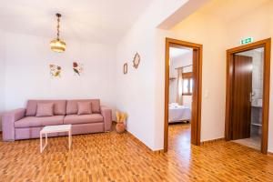 a living room with a couch and a table at Enalia Suites in Amoopi +36 photos
