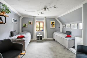a living room with two beds and a couch at Bed & Breakfast Hobro in Hobro
