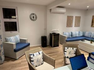 a living room with chairs and a table with a laptop at Korail Bleu in Rodrigues Island