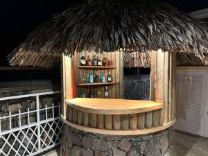a bar with a straw roof on top at Korail Bleu in Rodrigues Island