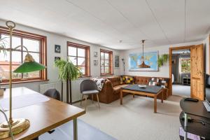 a living room with a couch and a table at Bed & Breakfast Hobro in Hobro