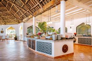 a large room with a counter with dishes on it at Bluebay Beach Resort & Spa in Kiwengwa