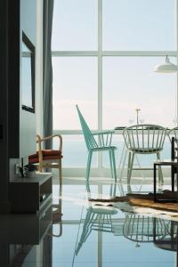 a room with chairs and a table and a window at Maritime Full Seaview Duplex Suites in George Town