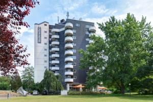 a tall building with a balcony on top of it at Ringhotel Parkhotel Witten in Witten