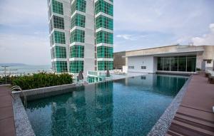 a building with a swimming pool in front of a building at Maritime Full Seaview Duplex Suites in George Town