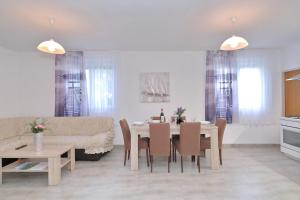 a dining room and living room with a table and chairs at Eda in Vrsi +34 photos