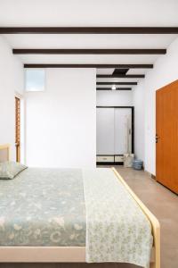 a bedroom with a large bed and a closet at MAK Mansion in Kotikulam