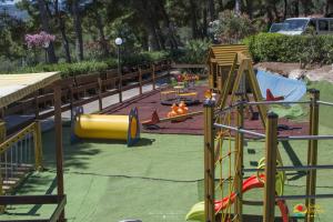 a playground with a slide in a park at Villaggio Santo Stefano in Vieste
