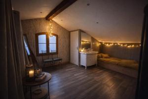 a bedroom with a bed and a sink and a mirror at La Maison cachée du PAVILLON BELLEVUE in Belley