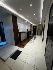 a hallway with a counter and chairs in a building at Deira Guest house by PHM in Dubai